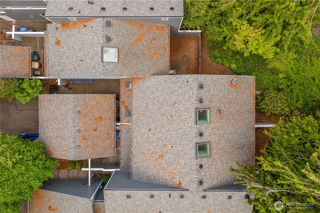 an aerial view of a house with a yard