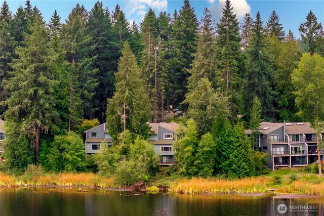 an aerial view of residential houses with outdoor space and swimming pool