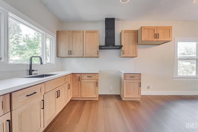 a kitchen with sink a window and cabinets