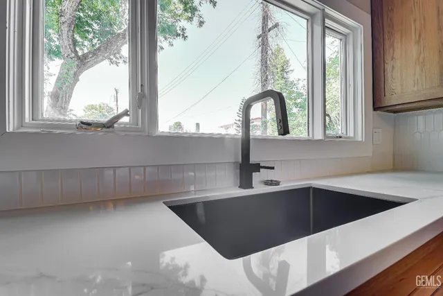 a kitchen with a sink and large window