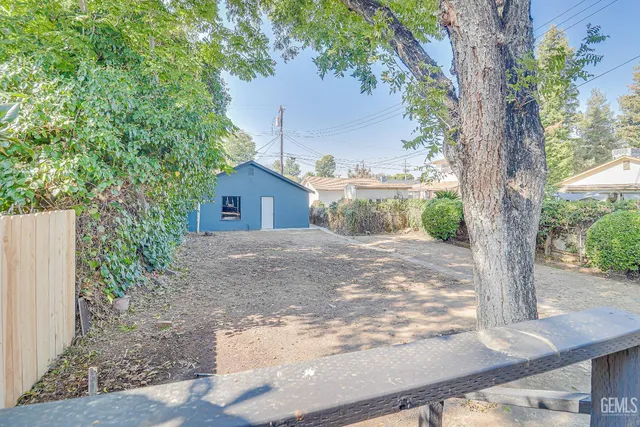 a view of a house with a tree in the background