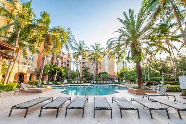 a swimming pool with outdoor seating and a garden