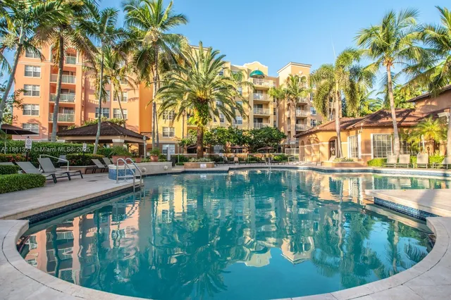a view of swimming pool with outdoor seating and plants
