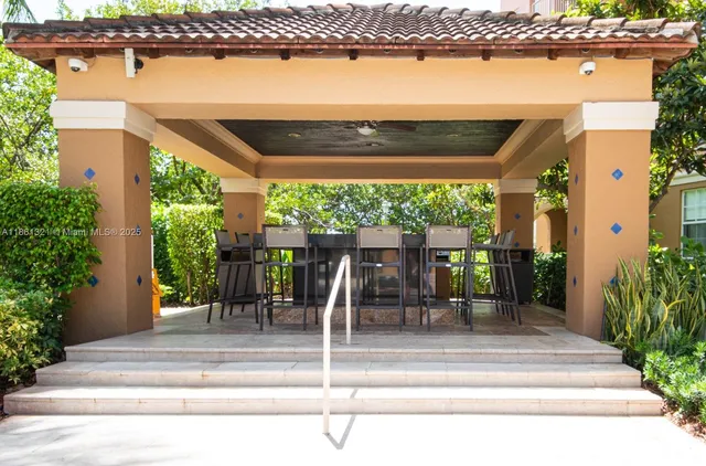 a view of a patio with a table chairs and a swimming pool
