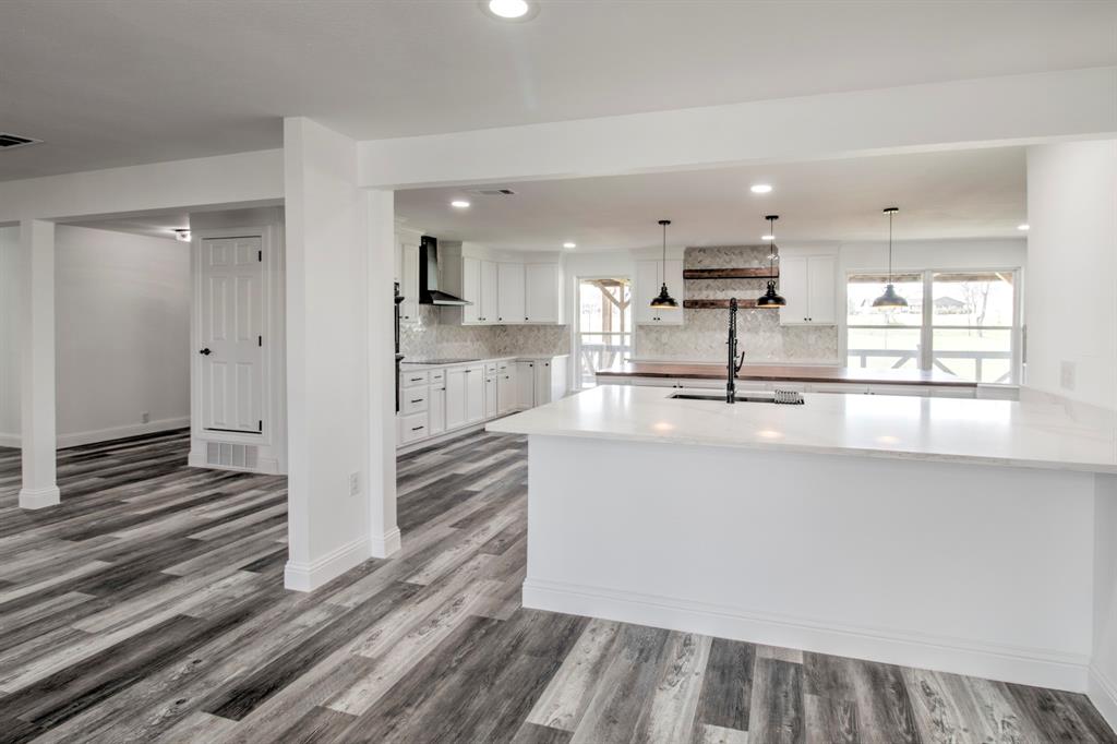 3884 Lois Road East Sanger, TX 76266 - Photo 15 of 40 a view of kitchen with wooden floor and window