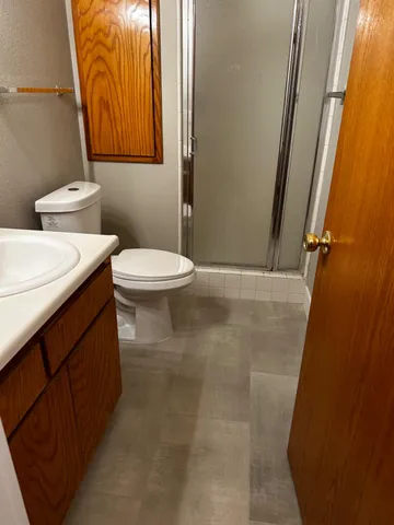a bathroom with a sink a toilet and shower curtain