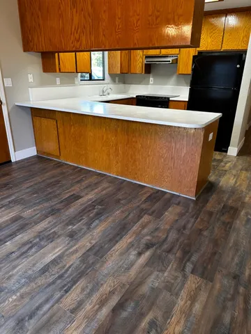 a view of a room with wooden floor