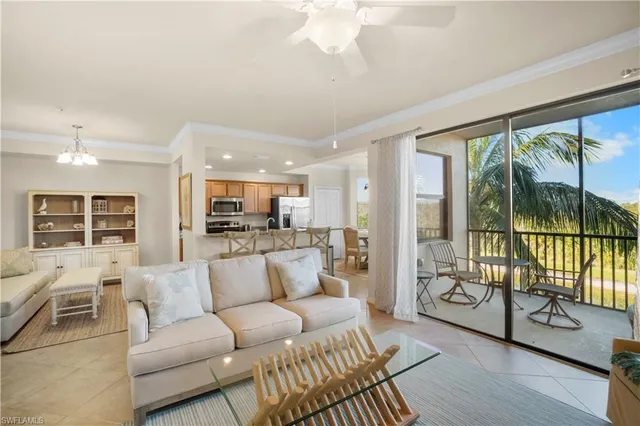 a living room with furniture and a large window with outer view