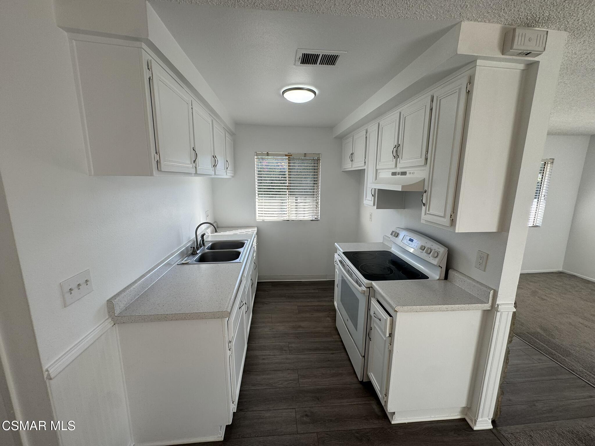 2030 Avenida Placida, Unit 4 Simi Valley, CA 93063 - Photo 5 of 18 a kitchen with a sink a stove and refrigerator