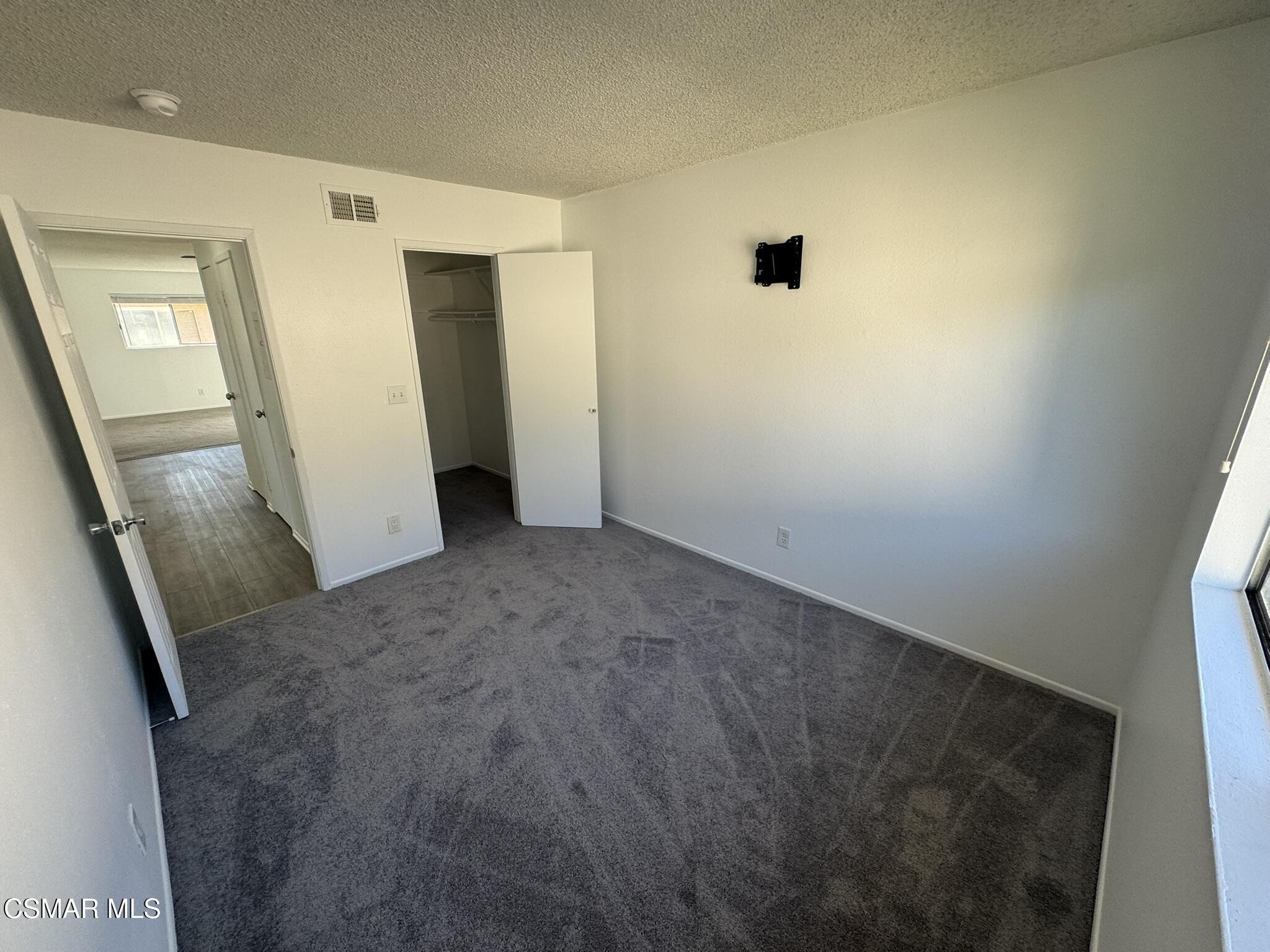 2030 Avenida Placida, Unit 4 Simi Valley, CA 93063 - Photo 9 of 18 a view of a hallway with wooden floor and a bathroom