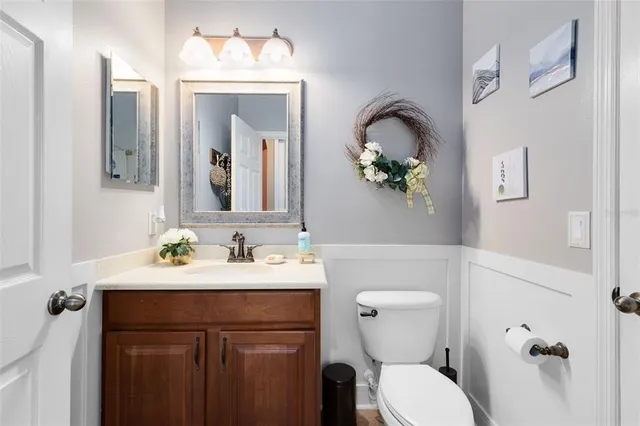 a bathroom with a toilet a sink and mirror