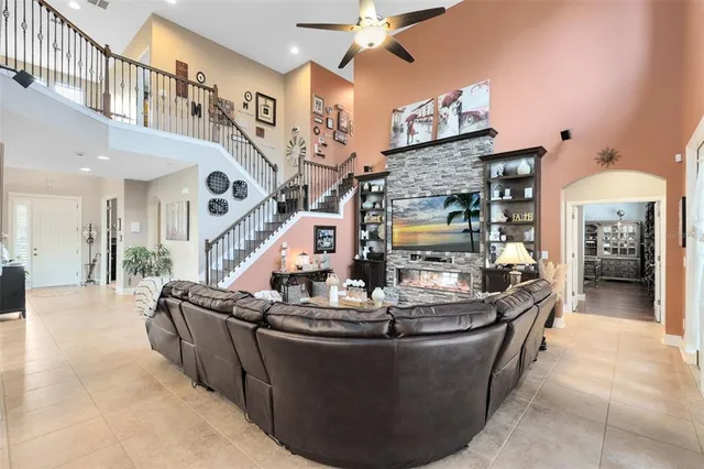 a living room with fireplace furniture and a chandelier
