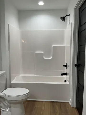 a bathroom with a bathtub and a toilet
