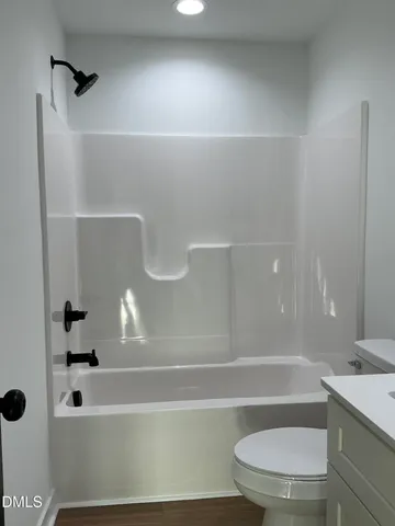 a bathroom with a bathtub and a toilet