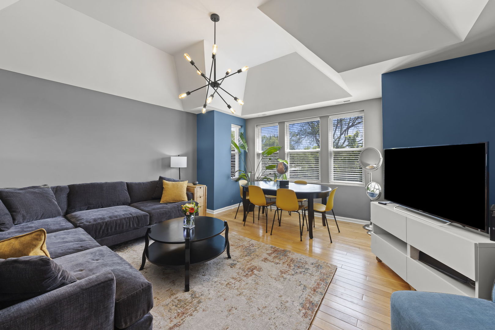 5054 North Troy Street, Unit 3 Chicago, IL 60625 - Photo 4 of 31 a living room with furniture and a flat screen tv