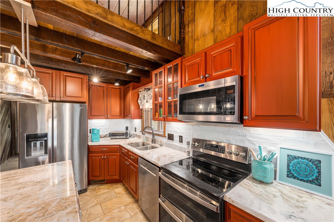 110 North River Lane Butler, TN 37640 - Photo 14 of 50 a kitchen with stainless steel appliances a stove and a microwave