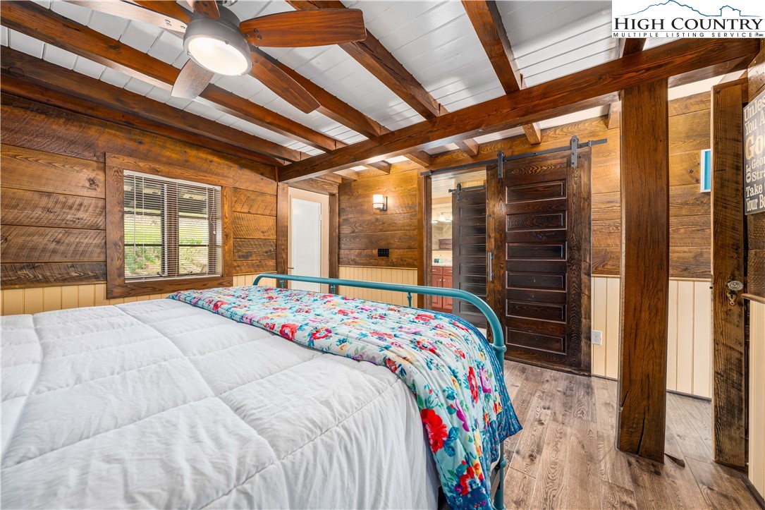 110 North River Lane Butler, TN 37640 - Photo 20 of 50 a bed sitting in a bedroom next to a window