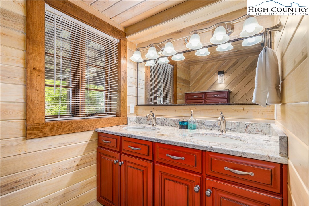 110 North River Lane Butler, TN 37640 - Photo 21 of 50 a bathroom with a granite countertop sink and a large mirror