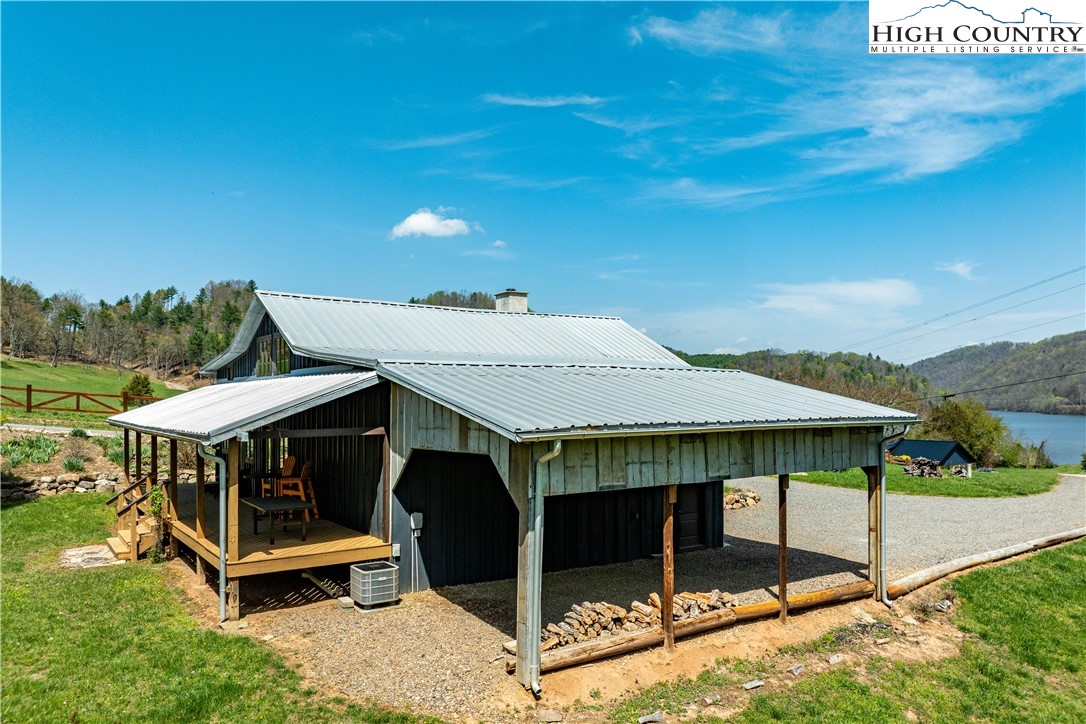 110 North River Lane Butler, TN 37640 - Photo 39 of 50 a view of a patio with table and chairs a barbeque with wooden fence and floor