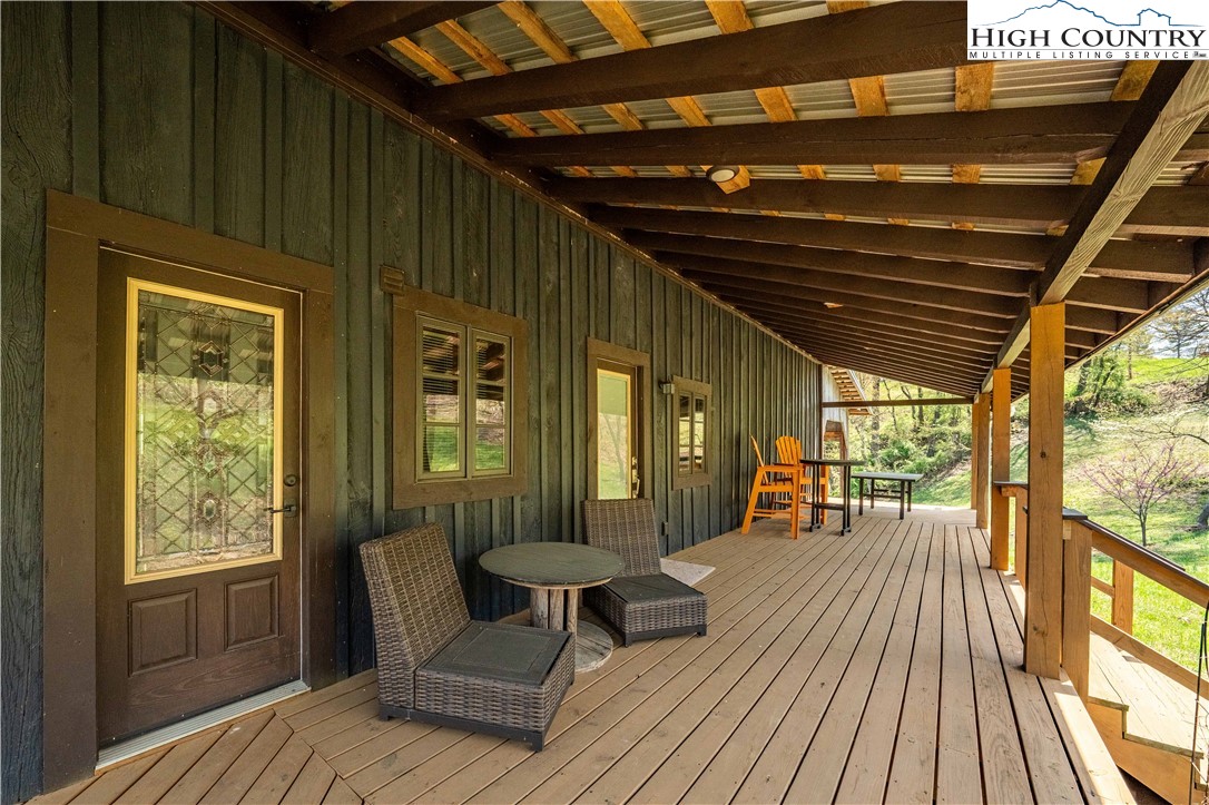 110 North River Lane Butler, TN 37640 - Photo 50 of 50 a balcony with wooden floor and outdoor seating