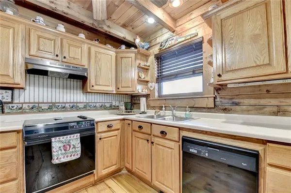 a kitchen with stainless steel appliances granite countertop a sink stove and cabinets