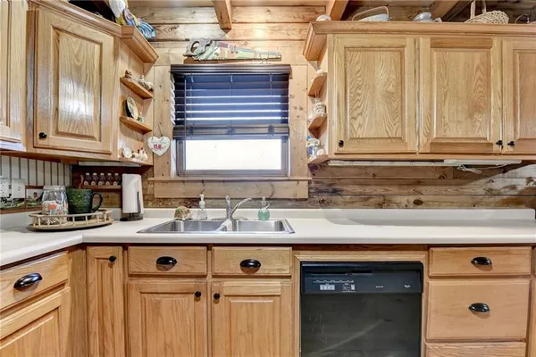 a kitchen with stainless steel appliances granite countertop a sink and a cabinets