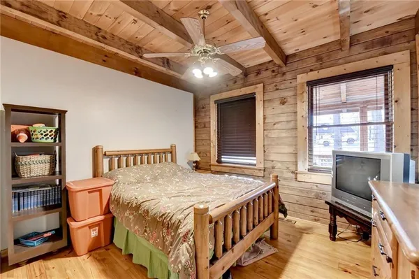 a bedroom with a bed next to a window