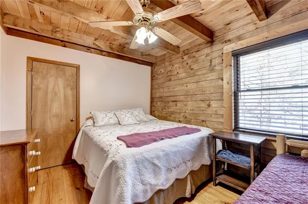 a bedroom with a bed next to a window