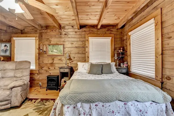 a bedroom with furniture and a fireplace