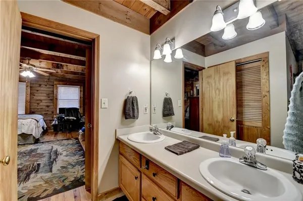 a bathroom with a double vanity sink and a mirror