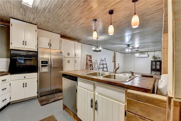a kitchen with stainless steel appliances a sink a stove and refrigerator