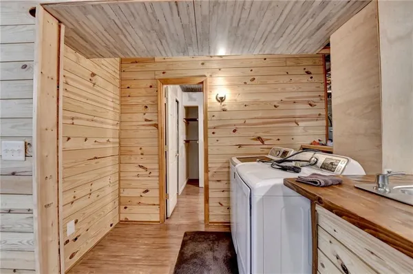 a bathroom with a granite countertop sink and a washing machine