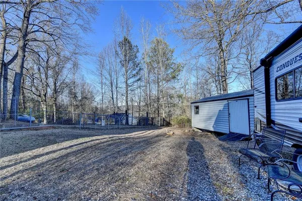 a view of a backyard with large trees