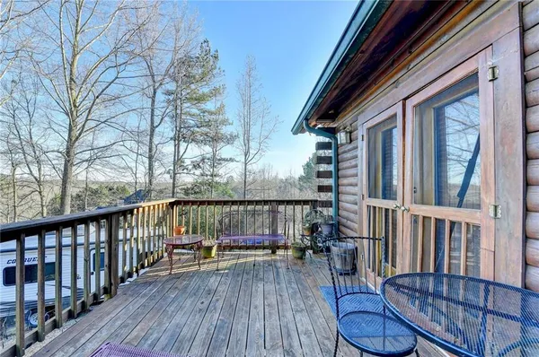 a view of balcony with wooden floor and outdoor seating