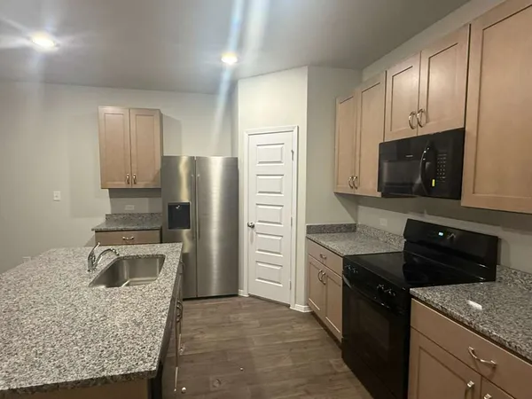a kitchen with a refrigerator stove and sink