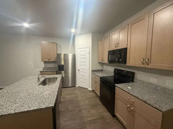a kitchen with a sink stove and microwave