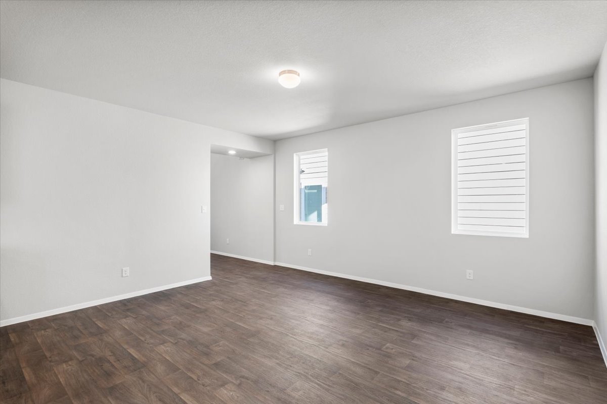 2711 Totley Road Manor, TX 78653 - Photo 19 of 40 an empty room with wooden floor and windows