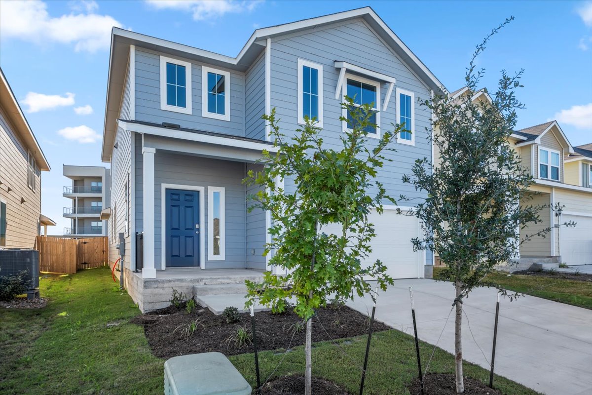 2711 Totley Road Manor, TX 78653 - Photo 2 of 40 a front view of a house with a yard