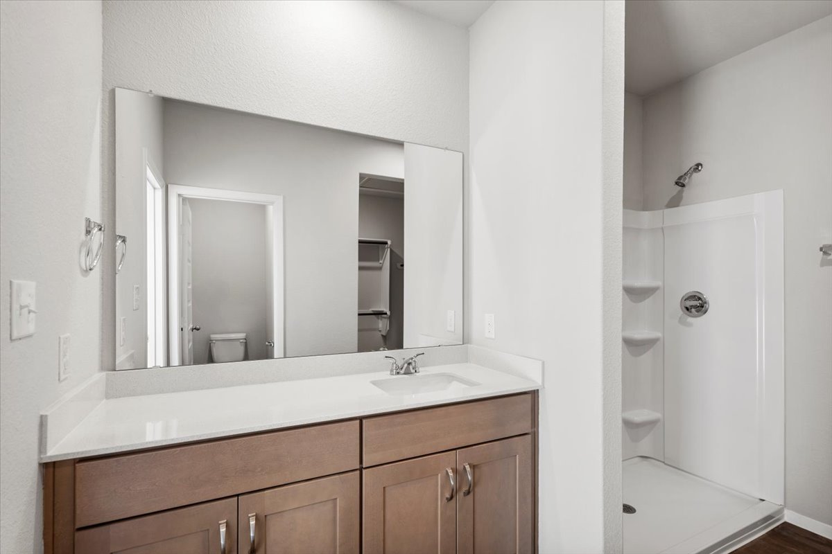 2711 Totley Road Manor, TX 78653 - Photo 22 of 40 a bathroom with a shower sink and mirror