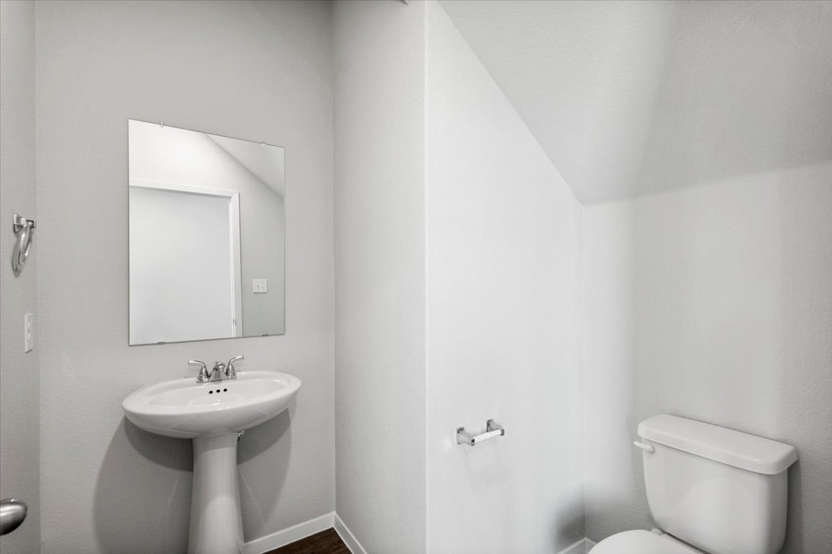 2711 Totley Road Manor, TX 78653 - Photo 25 of 40 a bathroom with a sink toilet and a mirror