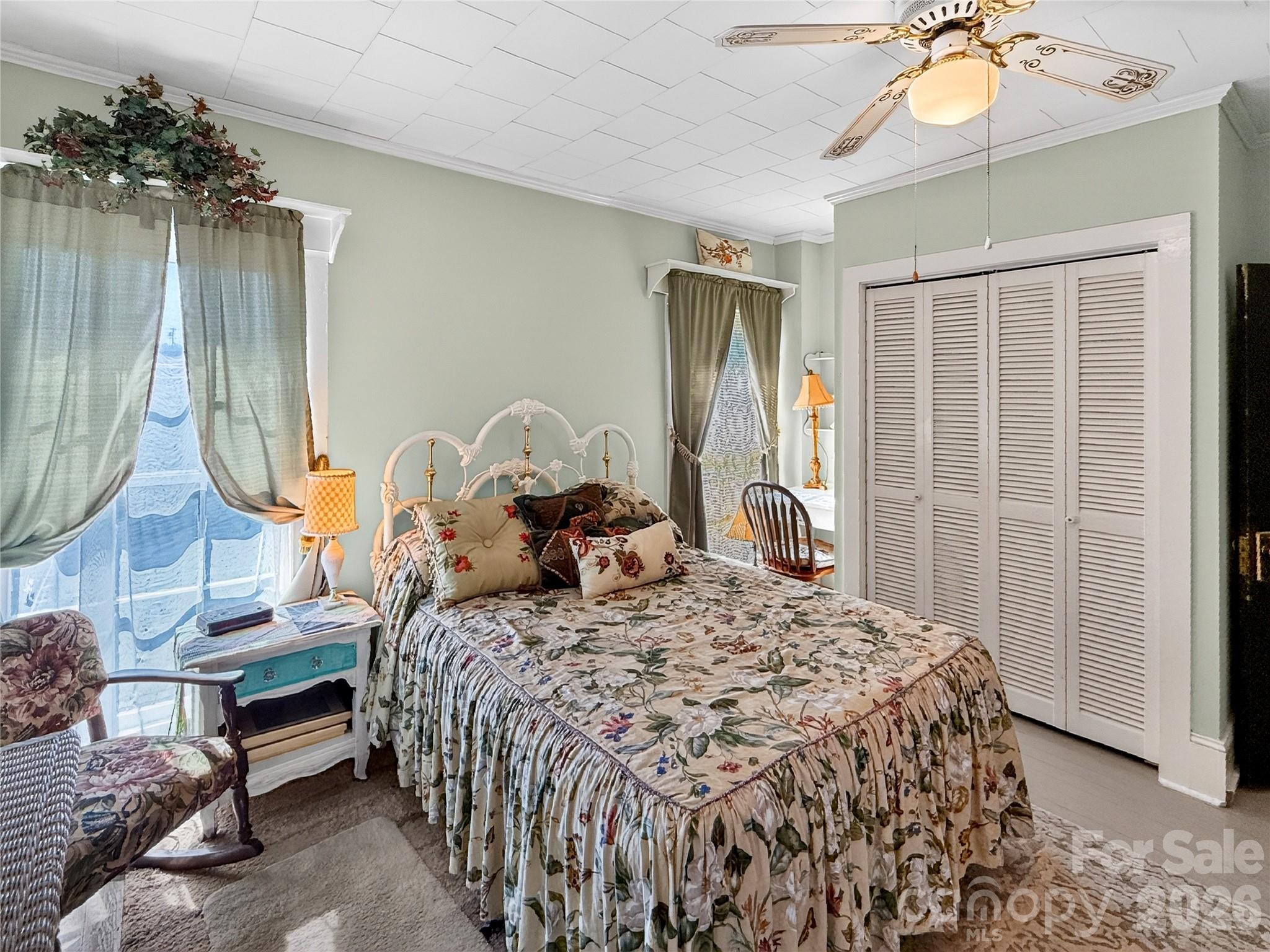 192 West Court Street Rutherfordton, NC 28139 - Photo 26 of 36 a bedroom with a bed and a chandelier