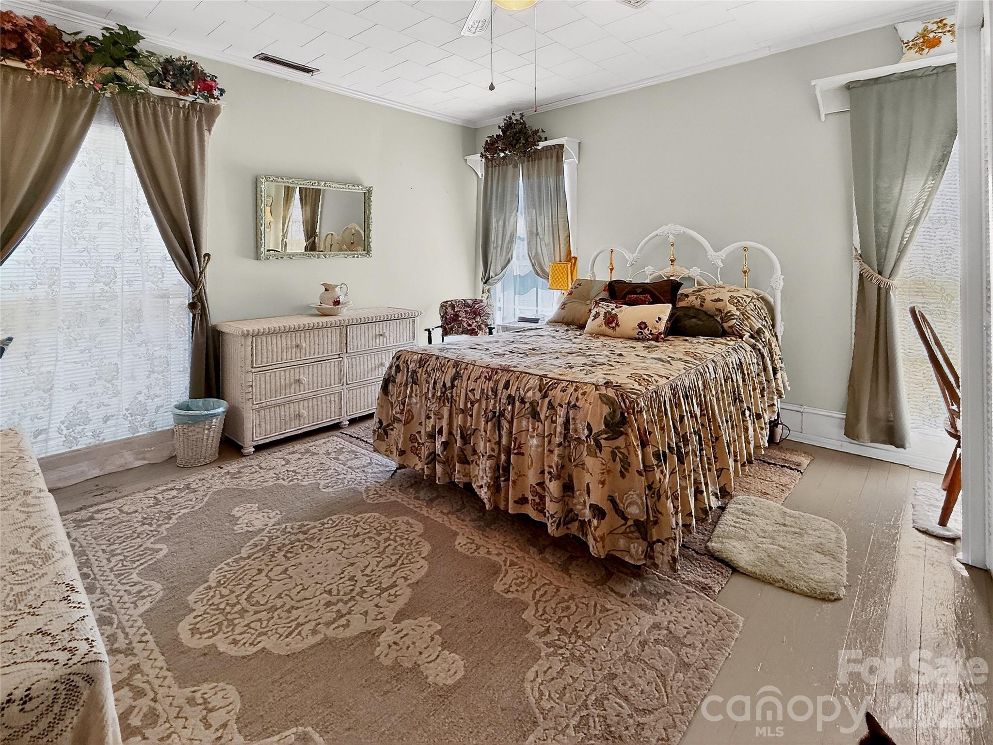 192 West Court Street Rutherfordton, NC 28139 - Photo 27 of 36 a spacious bedroom with a bed a couch and dresser