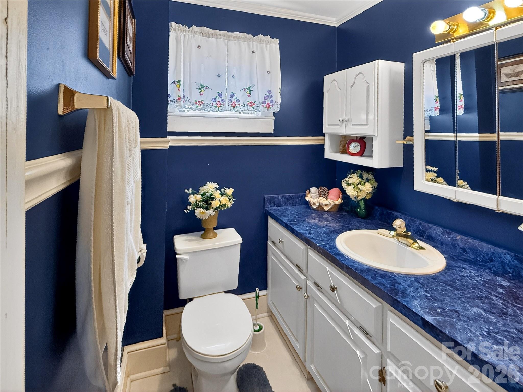 192 West Court Street Rutherfordton, NC 28139 - Photo 28 of 36 a bathroom with a granite countertop toilet sink and mirror