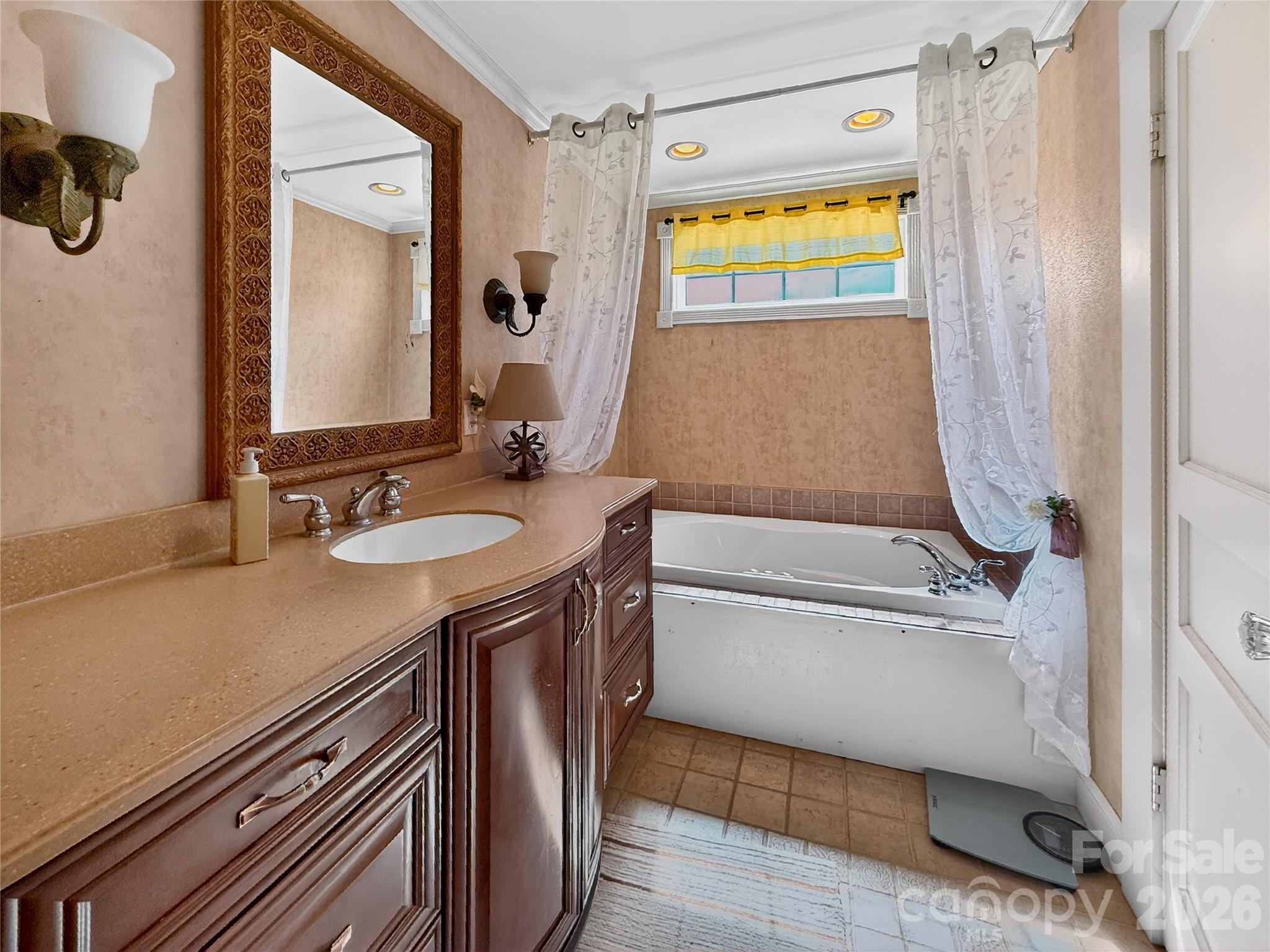 192 West Court Street Rutherfordton, NC 28139 - Photo 10 of 36 a bathroom with a granite countertop sink a mirror and a bathtub