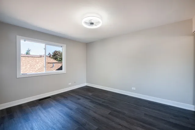 a bathroom with a sink vanity mirror and toilet