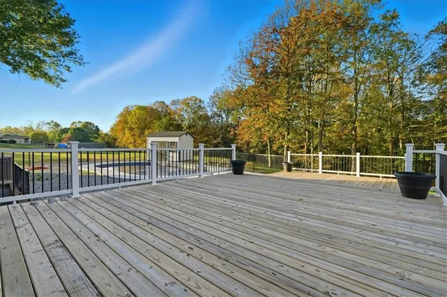 a view of a balcony with wooden floor and fence