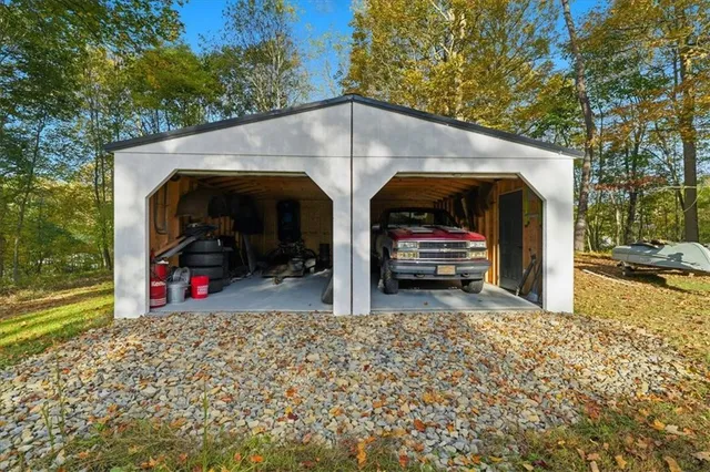 a backyard of a house with a yard and large tree