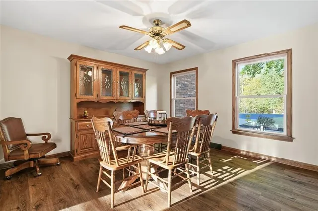 a view of a dining room with furniture a chandelier and wooden floor