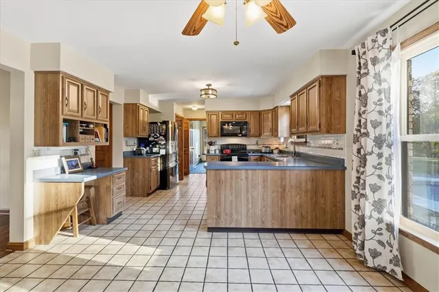 a kitchen with stainless steel appliances granite countertop a stove top oven a sink dishwasher and cabinets