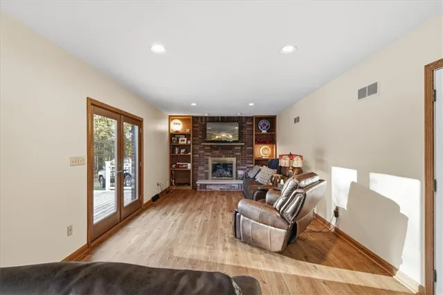 a living room with furniture and a wooden floor